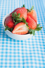 Small bowl filled with succulent juicy fresh ripe red strawberri