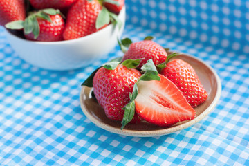 Small plate filled with juicy fresh ripe red strawberries