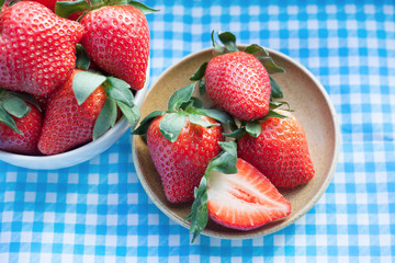 Small plate and bowl filled with succulent juicy fresh ripe red