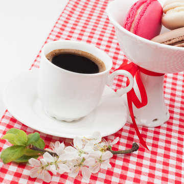 Coffee cup with and colourful french macaroons in vase  festive