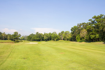 Golf course green grass with cloudscape in background