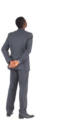 Businessman standing with hands behind back