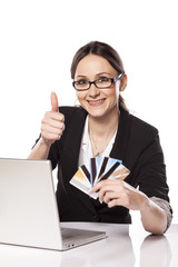 Happy Woman shopping online with credit card and laptop