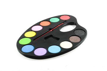 black art palette with paint and brushes isolated on whi