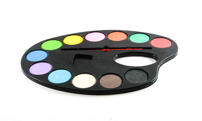 black art palette with paint and brushes isolated on whi