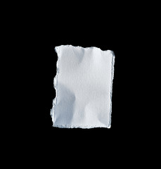 Scrap of white paper on black background