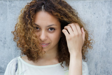 Fototapeta premium Elegant young woman posing with hand in hair