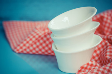 Different tableware on  table. white kitchen bowls