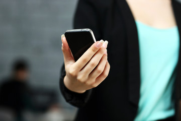 Closeup portrait of a female hands using smartphone in office