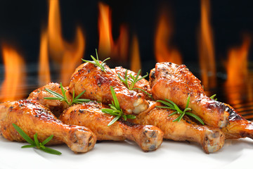 Grilled chicken legs on white plate.
