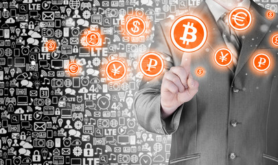 Choosing bitcoins, businessman pressing touch screen button.