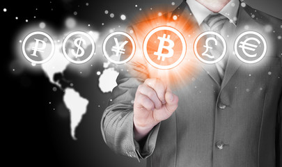 Choosing bitcoins, businessman pressing touch screen button.