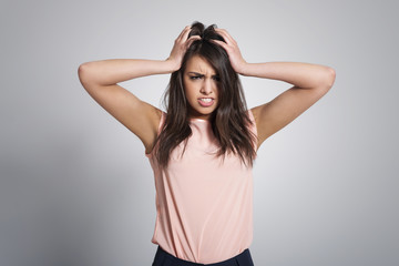 Fototapeta premium Portrait of angry woman with hand on head