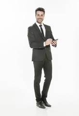 handsome man in suit texting on a phone on isolated background