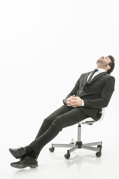 man in suit asleep on a chair  on isolated background