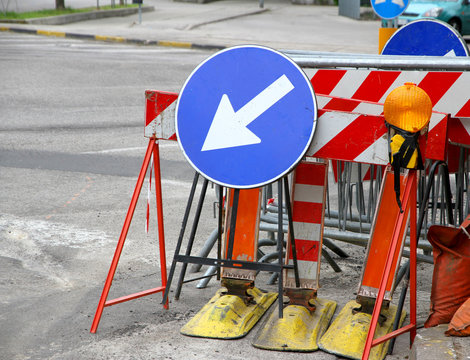 road signs with a large arrow to identify the place of work in p