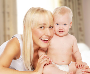 Happy mother with baby at home