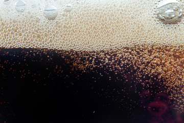 Macro bubble and  foam on the glass wall of cola - obrazy, fototapety, plakaty