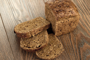 Slices of brown bread on a wooden table