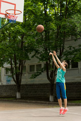 Teenage girl playing basketball
