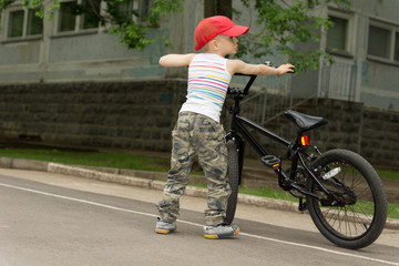 Cute macho little boy with his bicycle