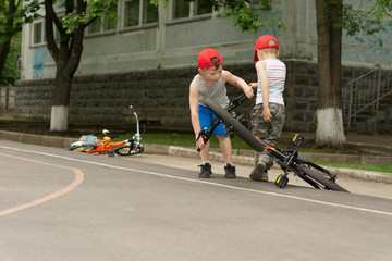 Two little boys playing with their bicycles