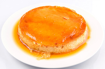 Caramel pudding on a white plate