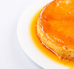 Caramel pudding on a white plate