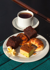  breakfast with a cup of coffee or tea with sweet rolls, muffins