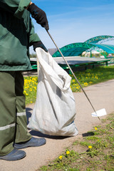 Road Sweeper Janitor cleaning street with pointed steel pin tool