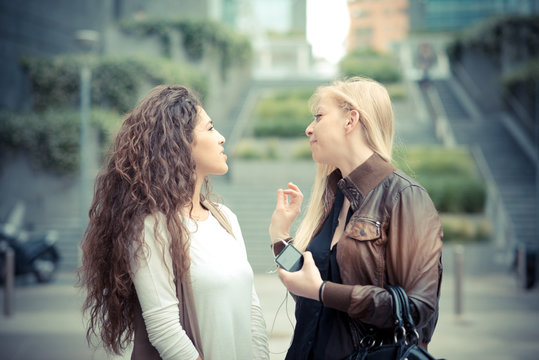 blonde and brunette beautiful stylish young women