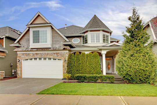 House with stone wall trim and column porch