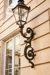 Fototapeta na wymiar Old wrought iron lamp on a building exterior