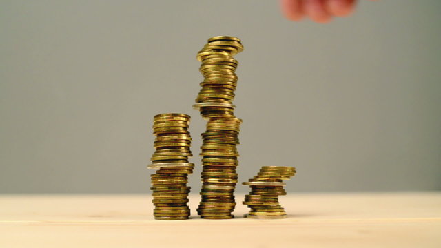 Hand stacking coins. Saving money, managing home budget. 