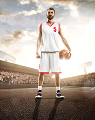 Basketball player in action on background of sky and crowd