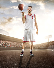 Basketball player in action on background of sky and crowd