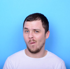 Portrait of man with funny face against blue background