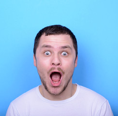 Portrait of man with funny face against blue background