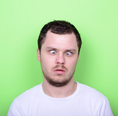Fototapeta premium Portrait of man with funny face against green background