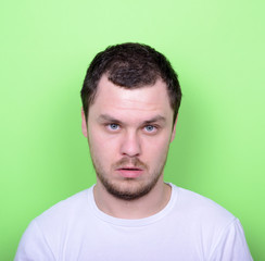 Fototapeta premium Portrait of man with funny face against green background