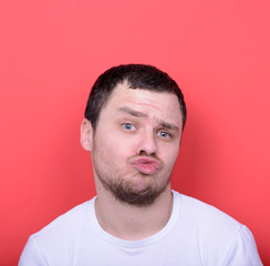 Obraz premium Portrait of man with funny face against red background