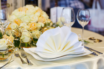 Elegant table set in green and white for wedding or event party.