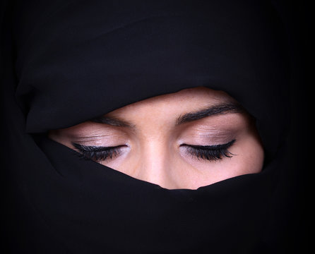 Portrait of beautiful Arab woman wearing black scarf