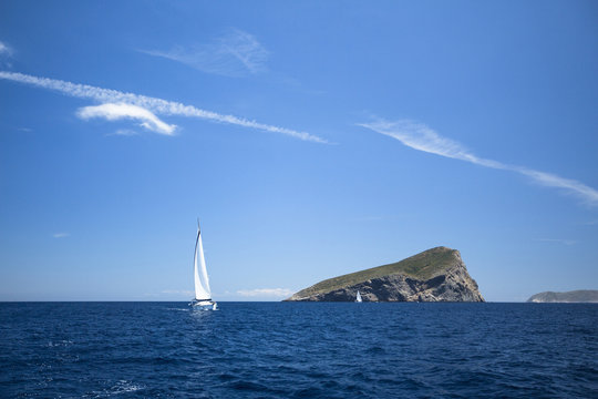 Sailing yachts with white sails in the sea. Luxury yachts.