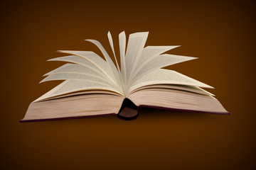 Open old book on brown background