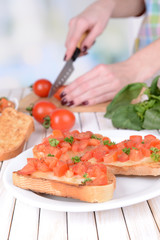 Delicious bruschetta with tomatoes on plate on table close-up