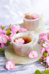 Beautiful fruit blossom with cup of tea