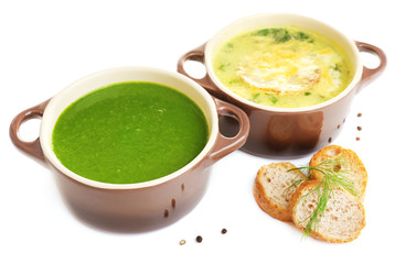 Tasty soup in saucepans, isolated on white