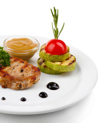 Grilled steak and grilled vegetables on plate, isolated on