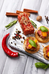 Composition of tasty sandwiches with salami sausage, basil leaf